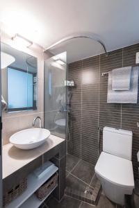 a bathroom with a sink and a toilet and a shower at Lux Downtown Sea View Apartment D3 in Thessaloniki