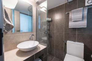 a bathroom with a sink and a toilet at Lux Downtown Sea View Apartment D3 in Thessaloniki +10 photos