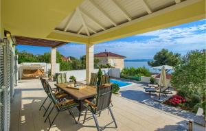 a patio with a table and chairs and a pool at Villa Tatijana in Zadar