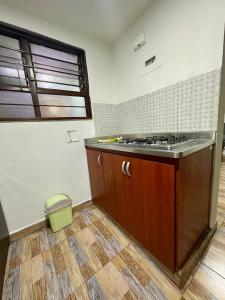an empty kitchen with a stove and a window at Apartamento en Envigado al Sur de Medellin in Envigado