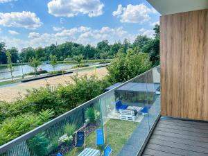 a balcony of a house with a view of a river at Aquarius 12 Stawy Walczewskiego in Grodzisk Mazowiecki