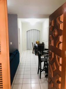 a living room with a blue couch and a table at Casa na Praia de Iracema R&S in Fortaleza
