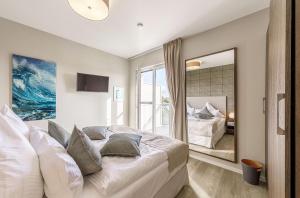 a bedroom with a large bed and a large mirror at Sommertraum - Charmante 3-Zimmer Wohnung mit Eckbalkon in Wustrow in Wustrow