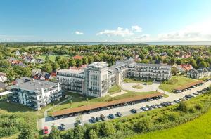 an aerial view of a building with a parking lot at Kleine Welle - Haustierfreundliches Zwei-Zimmer Apartment mit Südbalkon und Platz für drei Personen im ersten Obergeschoss in Wustrow