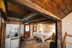 a bedroom with a bed and a television in it at SÍTIO Canjerana em Gramado in Canela