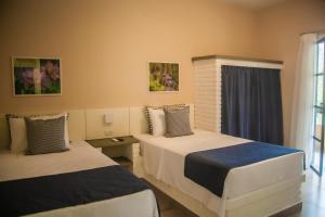 Postel nebo postele na pokoji v ubytování Matiz Igaratá Resort, Spa e Eventos