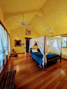 a bedroom with a bed with a mosquito net at Villa Divina at Framadani estate - Jungle villa with a pool in San Ignacio +84 photos