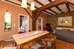 a dining room with a table and chairs at Ferienwohnung Lilie mit Balkon in einer geschmackvoll sanierten Backsteinmühle in Waren +12 photos