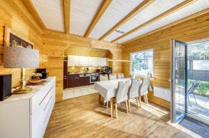 a kitchen and dining room with a table and chairs at Leif im Heidepark in Silz