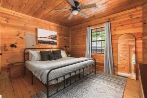 a bedroom with a bed and a ceiling fan at Mountain Retreat HotTub Pool PingPong Fireplace in Sevierville +66 photos