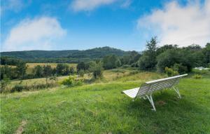 a white bench sitting in a field of grass at Nice Home In Chalabre With Wifi in Chalabre +9 photos