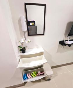 a bathroom with a white sink and a mirror at Coast Residences - 1 Bedroom with Balcony near PICC, WTC, Star City & MOA in Manila