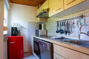 a small kitchen with a sink and a stove at MöwenKieker mit Terrasse im Ferienpark Silz in Silz +12 photos