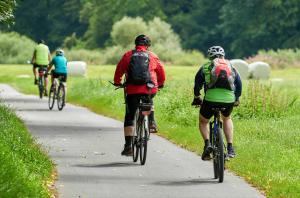 a group of people riding bikes down a road at Hafenoase mit Eckbalkon in Waren