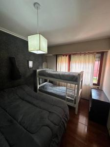 a bedroom with a bunk bed and a couch at Casa a 3 cuadras de la playa in Mar del Plata