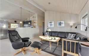 a living room with a couch and a table at Holiday Home Skodbjergevej Hvide Sande X in Havrvig