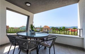 a patio with a table and chairs on a balcony at Villa Moonstone in Zadar