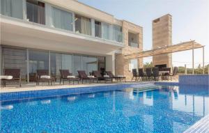 a swimming pool in front of a house at Villa Elegant in Splitska