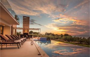 a house with a swimming pool with a sunset at Villa Elegant in Splitska +14 photos