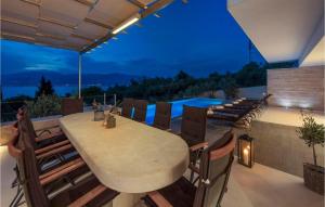 a patio with a table and chairs and a pool at Villa Elegant in Splitska