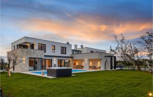 a large white house with a green yard at Villa Sole in Brtonigla