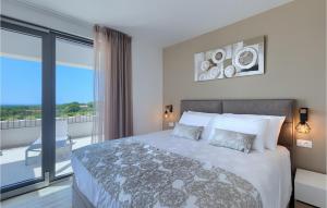 a bedroom with a large bed and a balcony at Villa Sole in Brtonigla