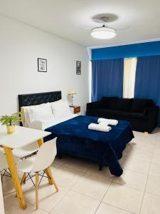 a bedroom with a bed and a table and a couch at Studio Apart 410 in Buenos Aires +1 photo