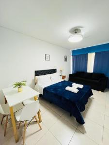 a bedroom with a bed and a couch and a table at Studio Apart 410 in Buenos Aires