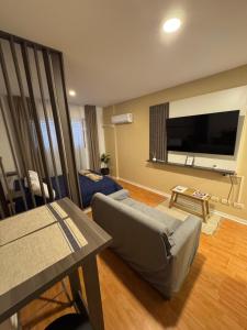 a living room with a couch and a large flat screen tv at Departamento en Rosario centro 1 in Rosario