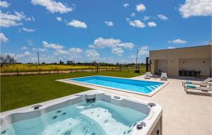 an outdoor hot tub in a yard with a patio at Villa Estate in Brtonigla