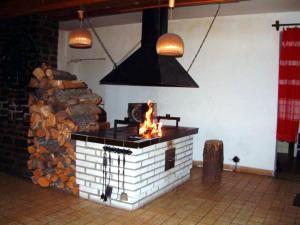 a brick fireplace with a fire in a room at Bungalovy Tatranec in Tatranská Lomnica