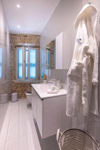 a white bathroom with a sink and a toilet at Vailato Swan White Suite in Corfu +32 photos