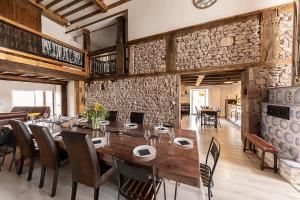 a dining room with a large wooden table and chairs at Aux draps de foin in Bellefontaine