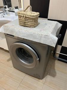 a basket on top of a washing machine with a sink at Appartement spacieux avec terrasse à 10 minutes du centre in Tangier +8 photos