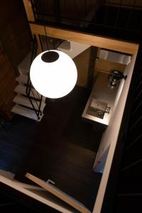 a white light hanging from a ceiling in a room at Satoyama Villa Honjin - Vacation STAY 17846 in Matsumoto