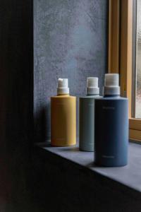 three bottles ofodorizers sitting on a counter next to a window at Satoyama Villa Honjin - Vacation STAY 17847 in Matsumoto