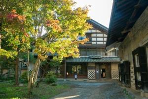 budynek z drzewem przed nim w obiekcie Satoyama Villa Honjin - Vacation STAY 17848 w mieście Matsumoto
