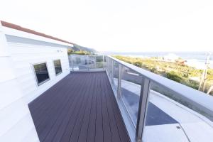a balcony with a view of the ocean at Kanasha Building A - Vacation STAY 49732v in Ōkachi +10 photos
