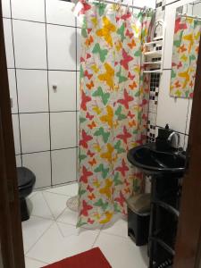 a bathroom with a shower with a toilet and a sink at Apartamentos Mãe Aparecida do Norte in Aparecida +22 photos