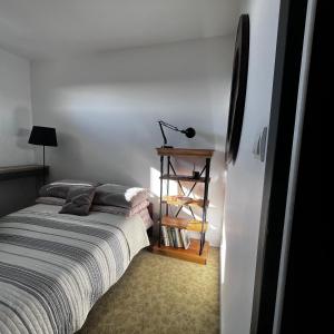 a bedroom with a bed and a lamp on a shelf at WieloApartment Radom - Paderewskiego in Radom