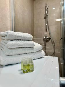 a pile of towels on a counter in a bathroom at Blancris Studio in Braşov