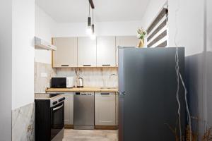 a kitchen with a stainless steel refrigerator at Lov&Mar apartment in Cvitović