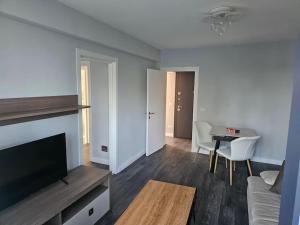a living room with a couch and a tv and a table at visitor's house in Suceava