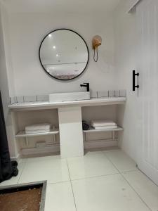 a bathroom with a sink and a mirror at Central Kendal Escape in Kendal