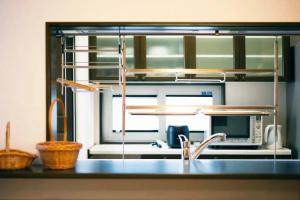 a kitchen counter with a sink and a microwave at Roopt Rikuzen Akai Ekimae - Vacation STAY 68980v in Higashimatsushima
