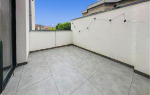 a balcony with a white wall and a tile floor at 1 Bedroom Nice Apartment In Oostende in Ostend