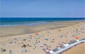 a group of people on a beach near the ocean at 1 Bedroom Nice Apartment In Oostende in Ostend