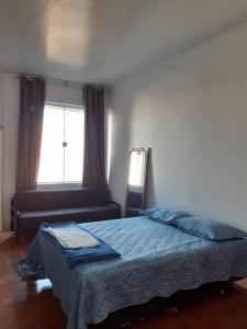 a bedroom with a bed and a window at Apartamento 112 Centro Consolaçao in Sao Paulo