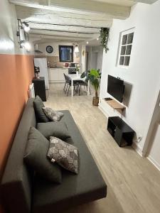 a living room with a couch and a dining room at Nancy Bricks Stan in Nancy
