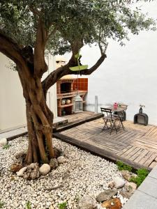 a tree in the middle of a patio with a table at IY Loft 5 - Spacious Loft in the Old Town in Valencia